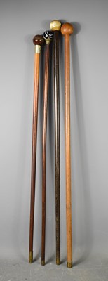 Lot 212 - Four vintage walking canes, of various woods,...