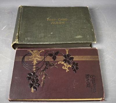 Lot 115 - Two albums of Edwardian and later postcards,...