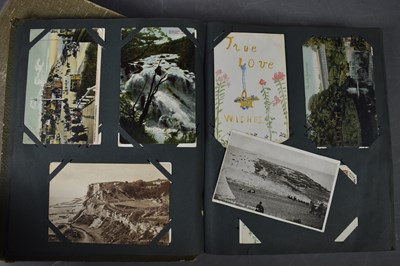 Lot 111 - Two albums of Edwardian and later postcards...