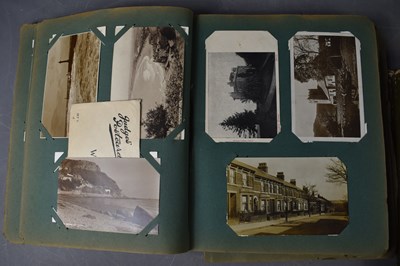 Lot 111 - Two albums of Edwardian and later postcards...