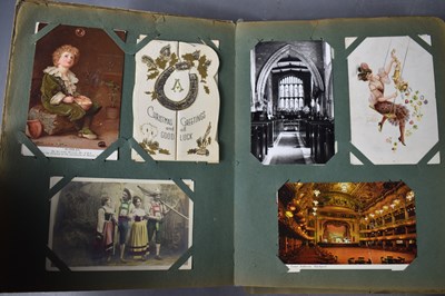 Lot 111 - Two albums of Edwardian and later postcards...