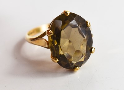 Lot 65 - A 9ct gold and smoky quartz dress ring, the...
