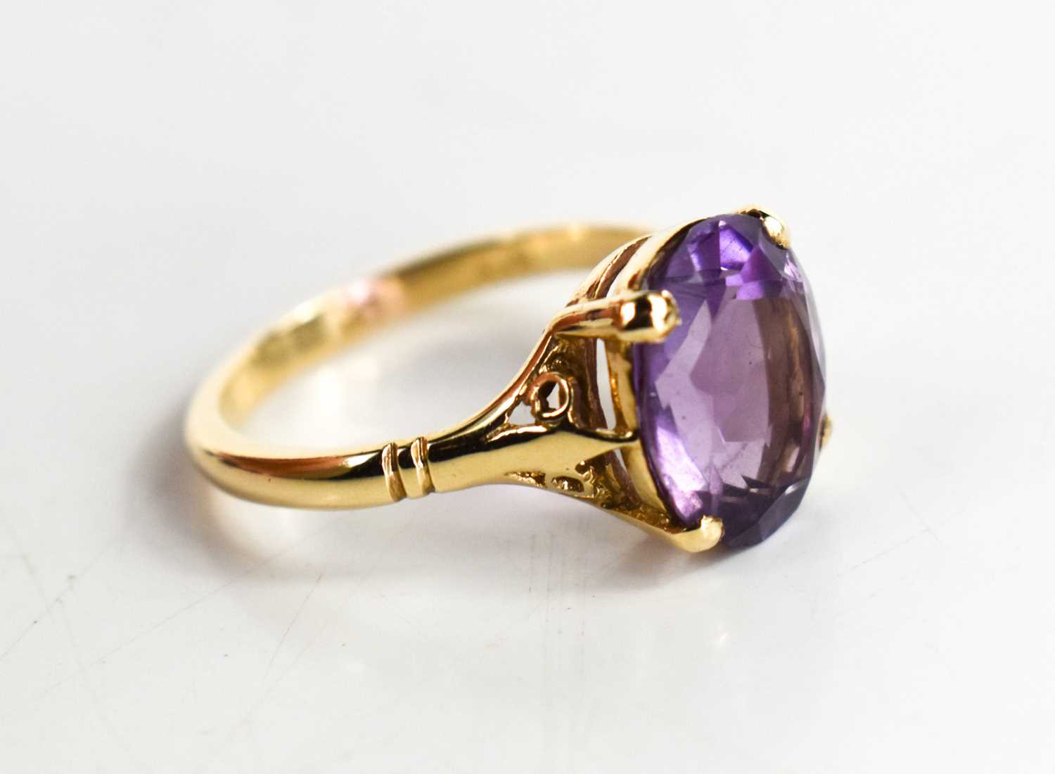 Lot 66 - A 9ct gold and amethyst dress ring, the oval...