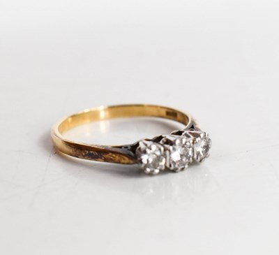 Lot 115 - A 9ct gold and diamond three stone ring, the...