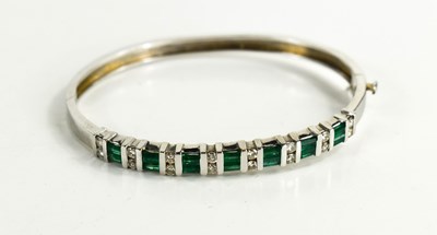 Lot 6 - A 14ct white gold, diamond and emerald demi...
