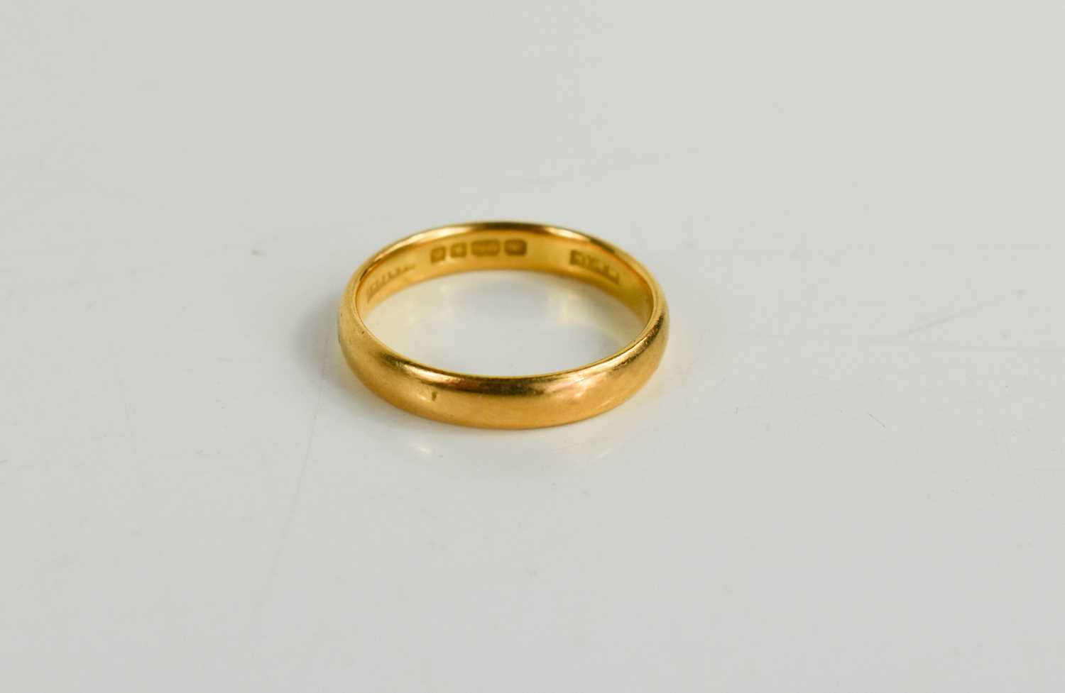 Lot 62 - A 22ct gold wedding band, size N/O, 3.86g.