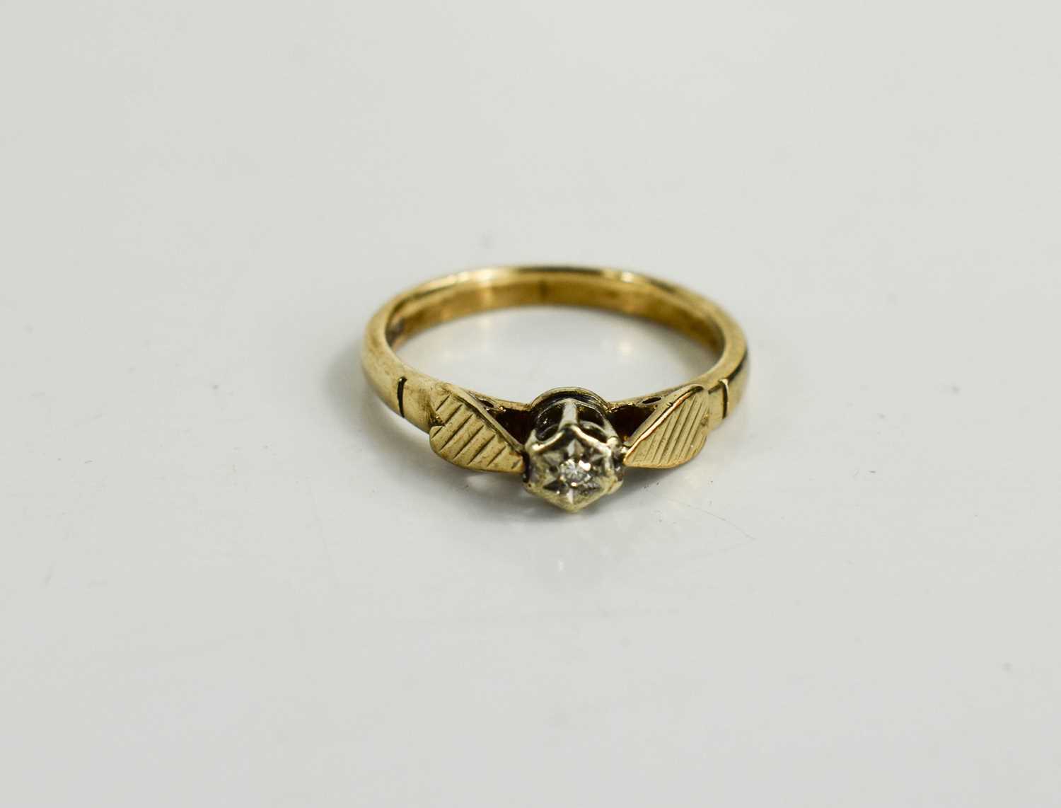Lot 42 - A 9ct gold and diamond illusion set solitaire...