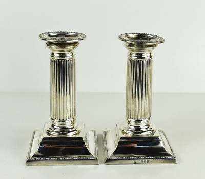 Lot 457 - A pair of silver column form candlesticks,...