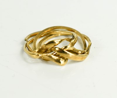 Lot 217 - A 9ct gold four piece puzzle ring, size O, 4.38g.