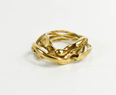 Lot 56 - A 9ct gold four piece puzzle ring, size V, 6.78g.