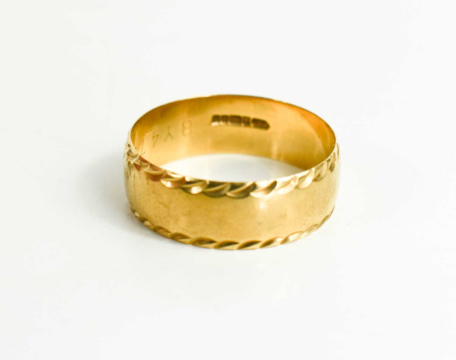 Lot 24 - A 9ct gold wedding band with rope twist...