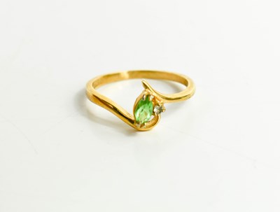 Lot 91 - An 18ct gold, peridot and diamond dress ring,...