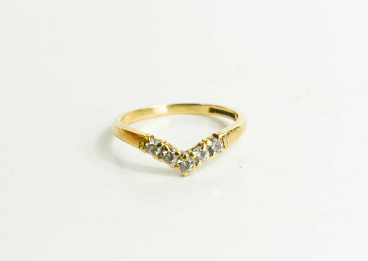 Lot 54 - A 9ct gold and diamond wishbone ring, set with...
