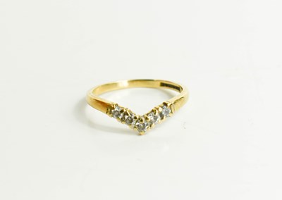 Lot 54 - A 9ct gold and diamond wishbone ring, set with...