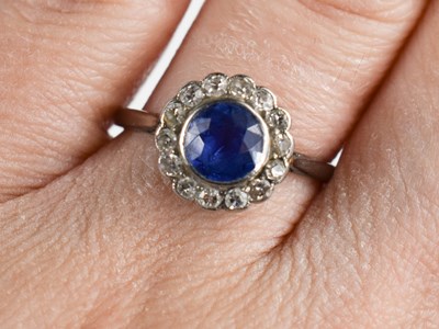 Lot 141 - An Art Deco sapphire and diamond flowerhead...