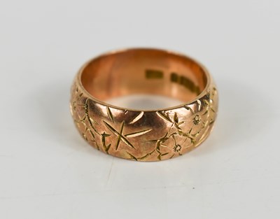 Lot 88 - A 9ct rose gold band, engraved with flowers,...