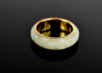Lot 21 - A 14ct gold and jade Chinese ring, with...