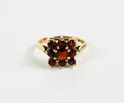 Lot 208 - A 9ct gold and garnet flowerhead ring, size O,...