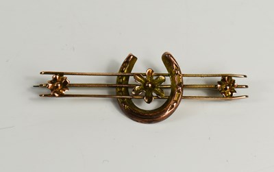 Lot 209 - A 9ct gold brooch, with horseshoe centred by a...