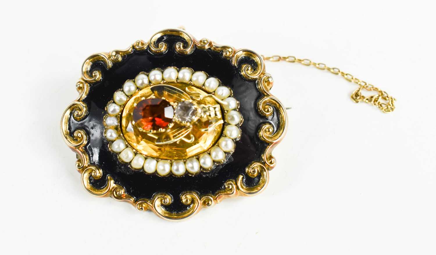 Lot 4 - A Victorian mourning brooch, the rococo scroll...