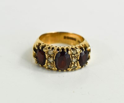 Lot 31 - A vintage 9ct gold garnet dress ring the three...