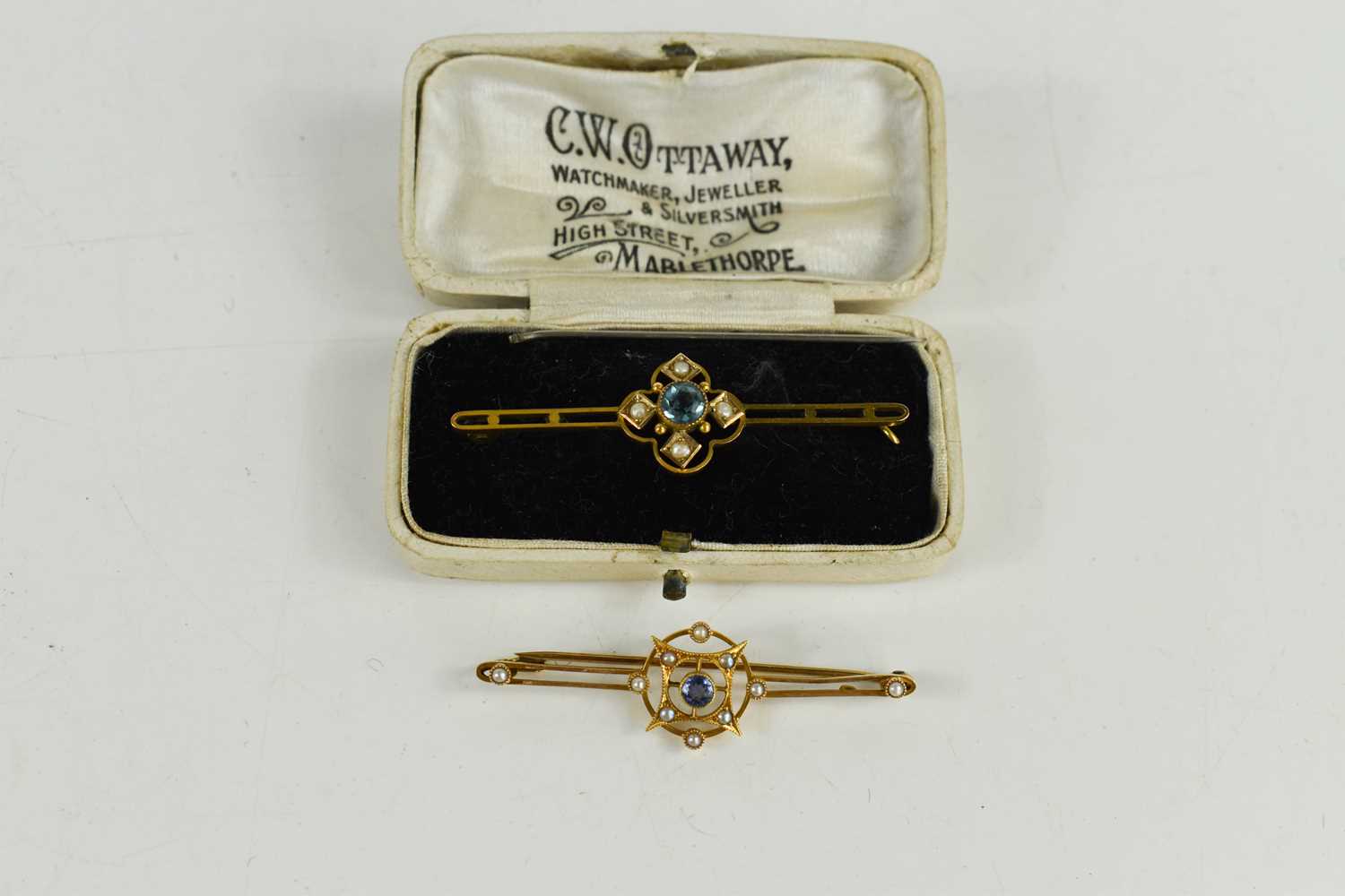 Lot 59 - A 15ct gold pale sapphire and seed pearl bar...