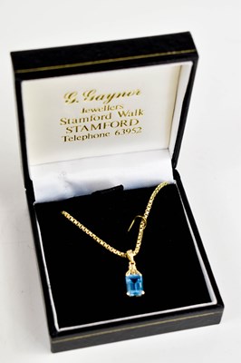 Lot 94 - A 14ct gold and blue topaz pendant, the...