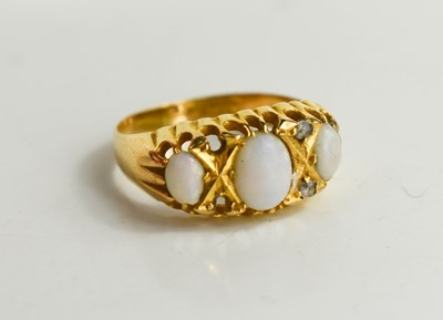 Lot 79 - An 18ct gold opal and diamond dress ring with...