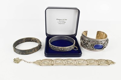 Lot 180 - Two silver bangles engraved with chased...