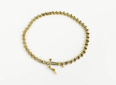 Lot 70 - A 10ct gold and diamond bracelet, the S form...