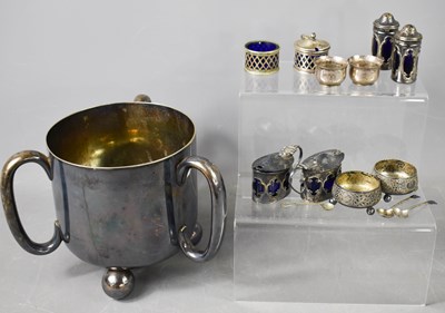 Lot 395 - A silver plated loving cup with three handles...