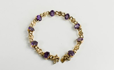 Lot 143 - A 9ct gold and amethyst bracelet with nine...