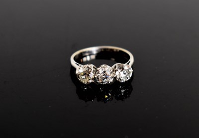 Lot 16 - A platinum and three stone diamond ring, the...