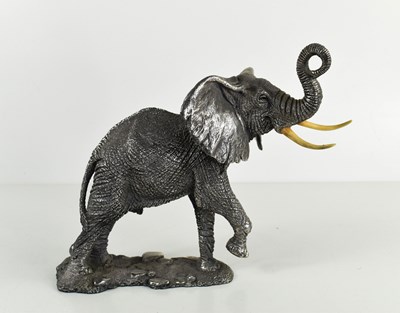 Lot 407 - A silver clad sculpture of an elephant,...