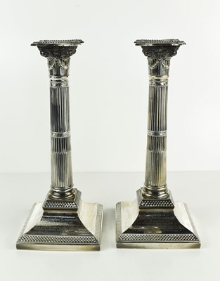 Lot 411 - A pair of silver column form candlesticks,...