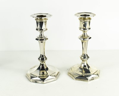 Lot 465 - A pair of silver candlesticks, with shaped...