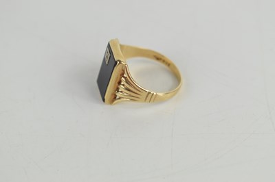 Lot 44 - A gentleman's 9ct gold, jet and diamond ring,...