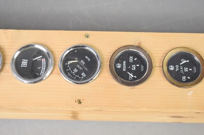 Lot 20 - A collection of vintage car dials mounted on a...