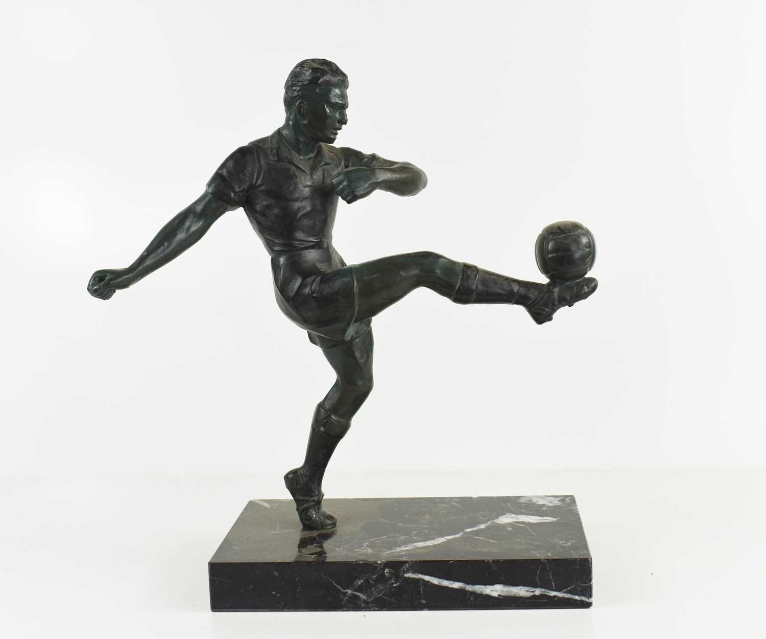 Lot 60 - A spelter figure of a footballer on black...