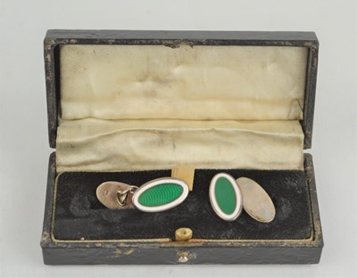 Lot 219 - A pair of silver and green enamelled oval form...