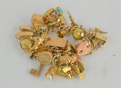 Lot 92 - A 9ct gold charm bracelet, 97g.