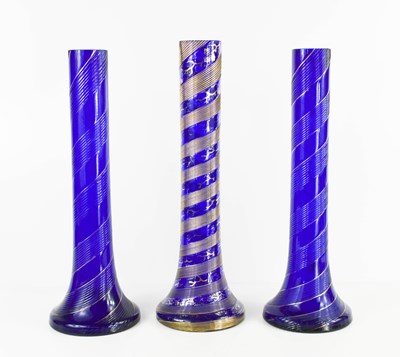Lot 96 - Three Victorian blue glass swirl vases.