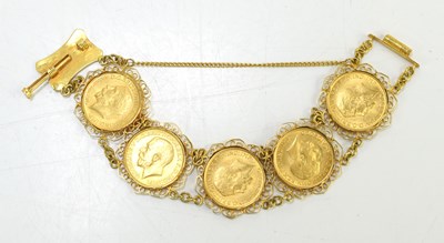 Lot 49 - An 18ct gold sovereign bracelet set with five...