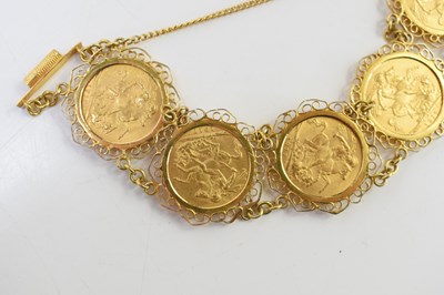 Lot 49 - An 18ct gold sovereign bracelet set with five...