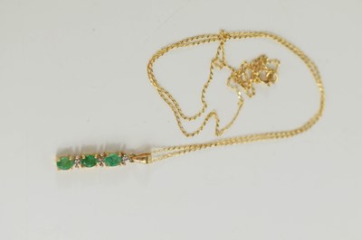 Lot 53 - A 9ct gold, emerald and diamond set pendant...