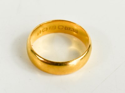 Lot 214 - A 22ct gold wedding band, L/M, 6g.