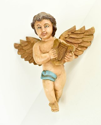Lot 30 - A 20th century polychrome winged cherub, 29cm...