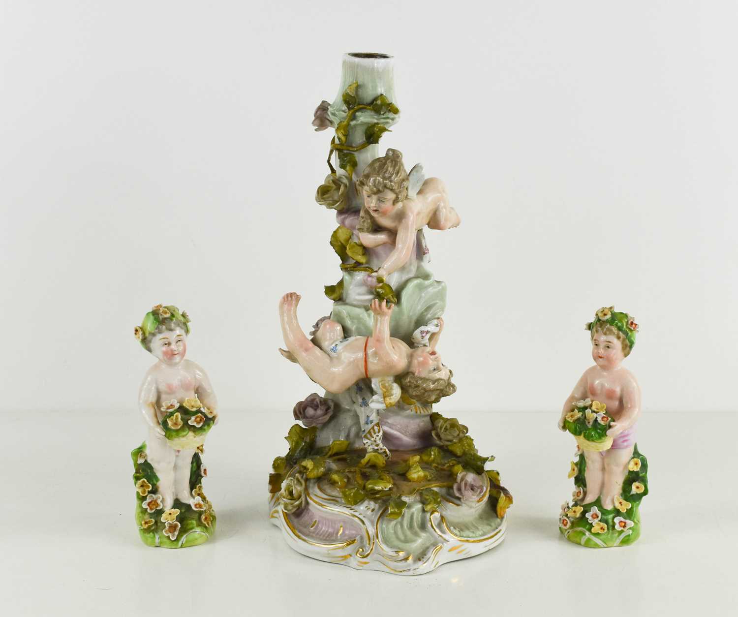 Lot 88 - A German porcelain candlestick modelled with...