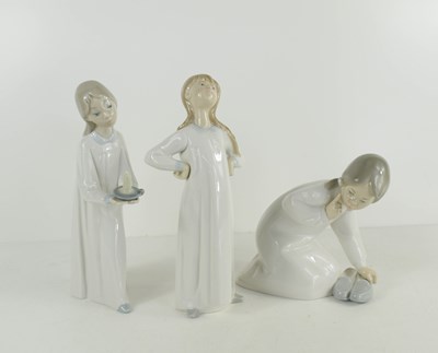 Lot 276 - Three Lladro figures of children in...