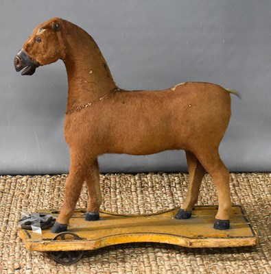 Lot 166 - A Victorian child's pull-along horse, clad...